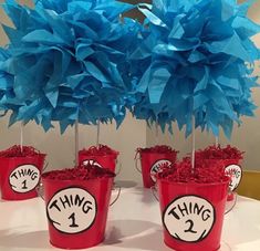 dr seuss thing 1 and thing 2 centerpieces in red buckets with blue tissue pom poms