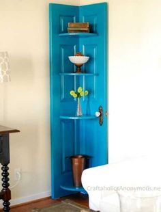 a living room with a white couch and blue bookcase