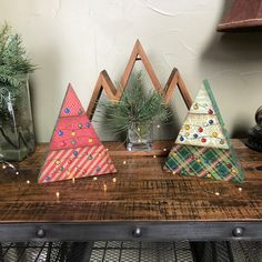 three small christmas trees are on a table