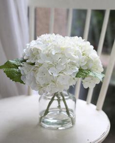 a vase filled with white flowers on top of a table