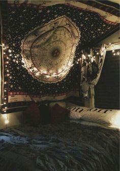 a bed with lights on it and a tapestry hanging over the headboard in front of it