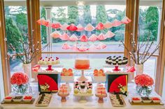 the dessert table is decorated with pink and red decorations