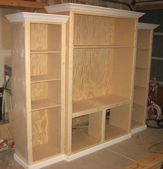 an unfinished bookcase is being built with plywood