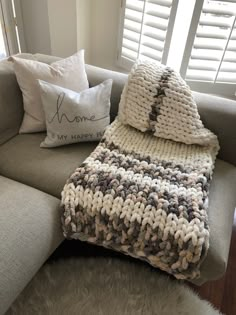 a crocheted blanket and pillows on a couch