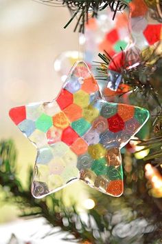 an ornament hanging from a christmas tree decorated with gummy bears and stars