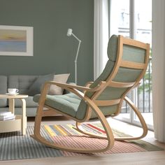 a living room with a rocking chair and rug