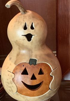 a ceramic pumpkin sitting on top of a table