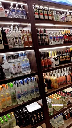 bottles of alcohol are on display in a liquor store