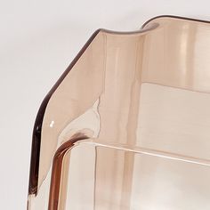 a brown glass vase sitting on top of a white table