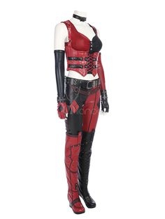 a woman in red and black leather outfit standing on a mannequin's head