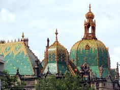 an ornate building with green and gold roof tiles