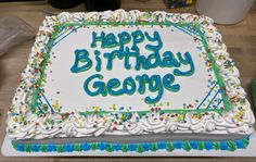 a birthday cake with the words happy birthday george written in blue and green frosting