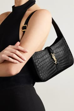 SAINT LAURENT's shoulder bag has a sleek, minimal silhouette that calls to mind coveted '90s styles. Made in Italy from black croc-effect leather, it's adorned with the house's signature 'YSL' plaque and has plenty of space for your phone, keys and cardholder.  You can easily adjust the buckled strap to your preferred drop. Ysl Saint Laurent, Expensive Bag, Satchel Tote Bag, Crocodile Pattern, Black Shoulder Bag, Saint Laurent Bag, Womens Purses, Branded Bags