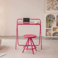 a pink desk with a laptop on it