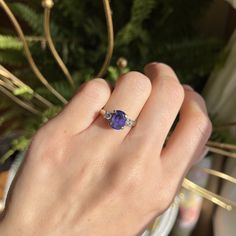 Vintage/ estate 14KT white gold oval-cut, faceted, violet tanzanite + diamond ring. Faceted, genuine, deep violet blue tanzanite prong set in 14KT white gold. Size 6.75 Can be resized for an additional fee Tanzanite measures: 9mm x 7mm Approximately 2.25-2.70 CT tanzanite 2 Round-cut, natural diamonds .15 CT per diamond; SI2 clarity; J/K color Weight: 3.88 grams Stamped 14K Evil Eye Hand, Saint Jewelry, Tanzanite Diamond Ring, Diamond Accent Ring, Tanzanite Diamond, Tanzanite Ring, Blue Tanzanite, Round Cut Diamond, Oval Cut