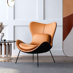 an orange chair and ottoman in a white room