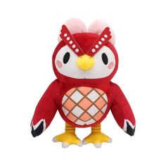 an owl stuffed animal with a red and white pattern on it's face, standing upright