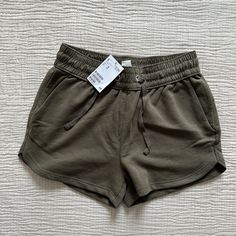 H&M Basic Shorts With Drawstring And Pockets. Size Xs, Never Been Worn! Green/Brown Color. H&m Stretch Shorts For Summer, H&m Shorts With Elastic Waistband, H&m Shorts For Summer Loungewear, H&m Casual Shorts With Elastic Waistband, H&m Casual Shorts With Pockets, H&m Stretch Shorts, H&m Casual Shorts For Spring, Casual H&m Shorts With Pockets, H&m Summer Loungewear Shorts