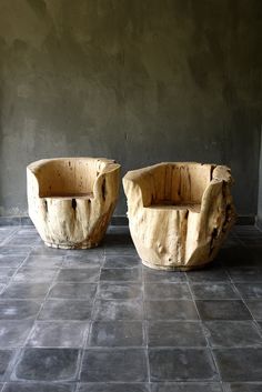 two stone planters sitting on top of a tiled floor