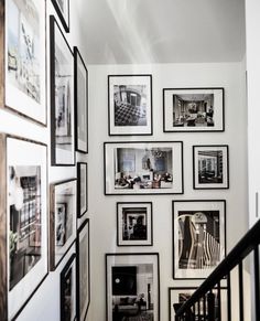 a staircase with many pictures on the wall