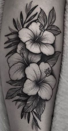 a black and white photo of flowers on the thigh, with some leaves around it