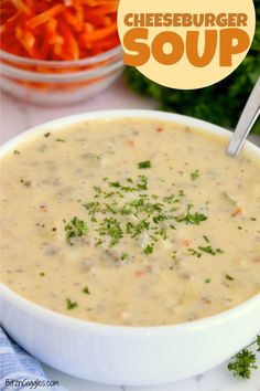 a bowl of cheeseburger soup with carrots and parsley in the background