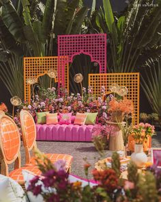 an outdoor seating area decorated with flowers and plants