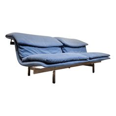 a blue couch sitting on top of a wooden frame