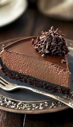 a slice of chocolate pie on a plate with a fork and napkin next to it