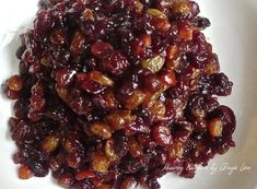 a white plate topped with cranberry sauce and nuts