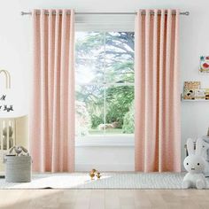 a child's room with pink curtains and stuffed animals