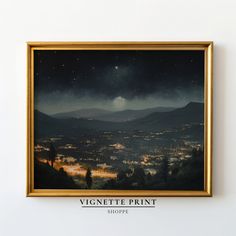 a painting hanging on the wall above it is an image of a city at night