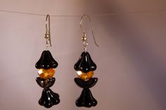 Delightful black and orange witch earrings. Perfect for Halloween or any time you feel a little bit witch Made using dyed fresh water pearls, Czech pressed glass beads,and pure sterling silver ear wires. Elegant Adjustable Halloween Earrings, Handmade Black Halloween Earrings, Handmade Spooky Black Earrings, Handmade Vintage Halloween Earrings, Orange And Black Beads Dangle Earrings, Magic Earrings, Witch Earrings, Black Witch, Earrings Halloween