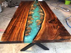 a table that has rocks in it and water running down the center section of it