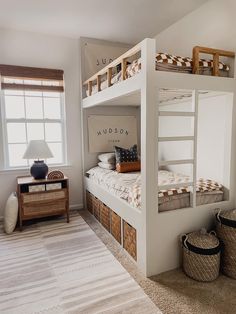 a bedroom with bunk beds and baskets on the floor