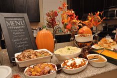 a table filled with lots of different foods and desserts on top of it's counter