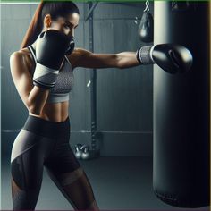 a woman wearing black and white boxing gloves punching a punching bag with her right hand