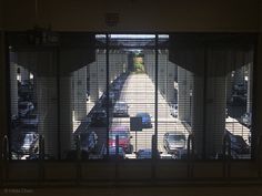 an overhead view of a parking lot with cars parked in the lot and behind bars