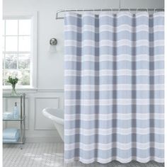 a white and blue shower curtain in a bathroom