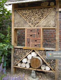 an outdoor firewood rack with logs in it