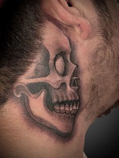 a man with a skull tattoo on his neck