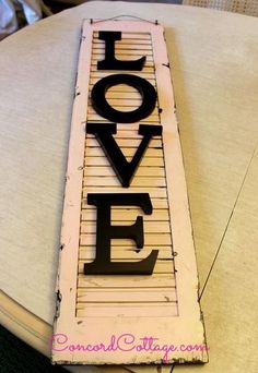 a wooden sign that says love on it