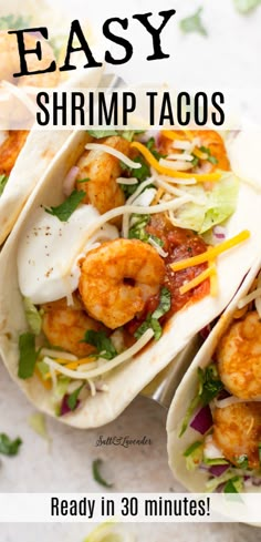 two shrimp tacos with lettuce and cheese on top