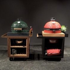 two large grills sitting next to each other on top of a wooden table with pots and pans