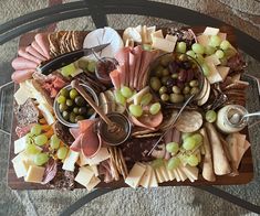 a table topped with lots of different types of cheese and crackers on top of it