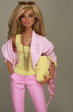 a barbie doll wearing pink pants and a yellow top with a purse on her shoulder