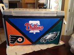 an ice chest decorated with the philadelphia eagles and philadelphia flyers logos on it's side