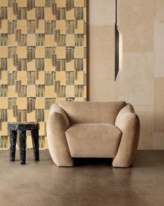 a chair sitting in front of a wall with books on it