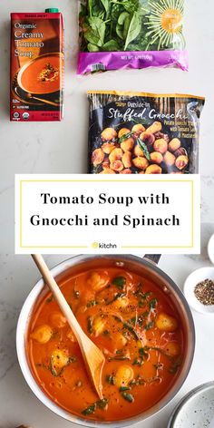 tomato soup with gnocchi and spinach in a white bowl on a marble counter top