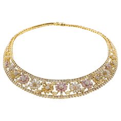 This beautiful and exquisite necklace is designed with a floral pattern set with natural fancy-color round and pear-shaped GIA-certified* pink, yellow, and white diamonds that are set in 18k yellow gold. The floral design is further encased in a row of diamonds; the total diamond weight in the necklace is approximately thirty-five carats and measures a total of 16 inches. *Two random pink diamonds on the necklace were tested as natural, pink by the Gemological Institute of America (GIA) Pink Diamond Necklace, Gold Necklace Diamond, Yellow Diamond Necklace, Diamond Collar, White Diamond Necklace, Glamorous Jewelry, The Bling Ring, Modern Gold Jewelry, Fancy Jewellery Designs